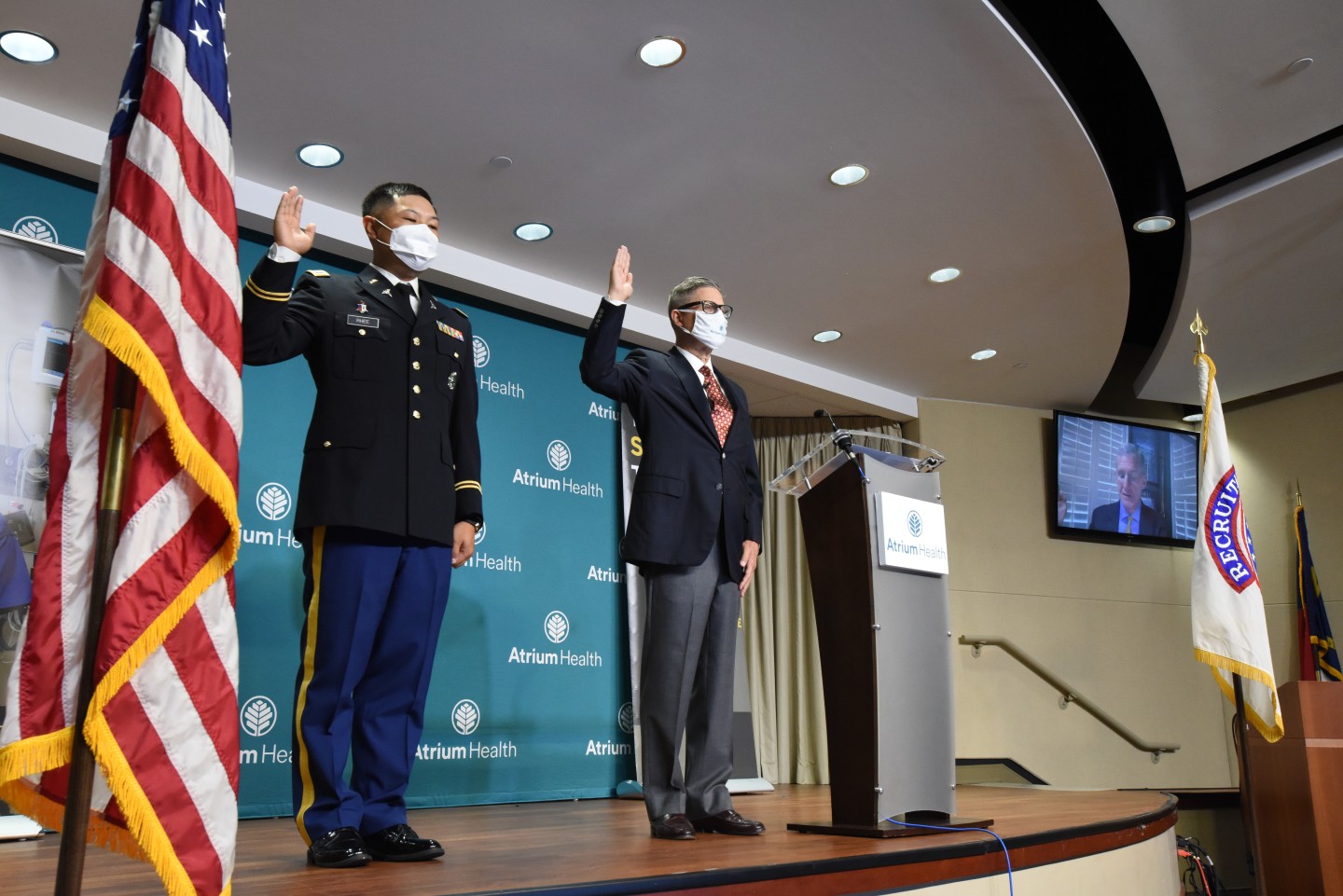 Caption: Dr. Lobdell raises his right hand at his commissioning ceremony on August 13, 2020, becoming a U.S. Army Reserve officer at sixty years old at Atrium Health. Gene Woods, CEO of Advocate Health, served as master of ceremonies. Photo courtesy of Dr. Kevin W. Lobdell.